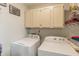 Functional laundry room featuring modern appliances and ample storage space at 5875 Annanhill Ct, Avon, IN 46123