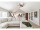 Open living room with vaulted ceilings, comfortable seating, and access to the kitchen and outdoor area at 5875 Annanhill Ct, Avon, IN 46123