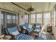 Cozy sunroom with brick accent wall and comfortable seating, ideal for relaxation at 5875 Annanhill Ct, Avon, IN 46123