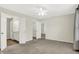Large bedroom boasts neutral walls, plush carpeting, and several doorways leading to other rooms at 6103 Pebblebrooke Rd, Whitestown, IN 46075