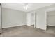 A bright bedroom features neutral walls, plush carpet, and doorways leading to the bathroom and closet at 6103 Pebblebrooke Rd, Whitestown, IN 46075