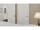 Cozy bedroom featuring plush carpeting, a lamp on the nightstand, and doorways at 6103 Pebblebrooke Rd, Whitestown, IN 46075