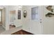 Bright foyer featuring wood floors, an ornate glass-paneled door, and a glimpse into a tiled bathroom at 6103 Pebblebrooke Rd, Whitestown, IN 46075