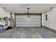 Spacious two-car garage with a white door, perfect for parking and storage at 6103 Pebblebrooke Rd, Whitestown, IN 46075
