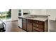 Well-lit kitchen featuring stainless steel dishwasher and sink, perfect for cooking and entertaining at 6103 Pebblebrooke Rd, Whitestown, IN 46075