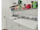 Functional laundry room with modern appliances, shelving, and ample storage space at 6103 Pebblebrooke Rd, Whitestown, IN 46075