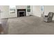 Bright living room featuring neutral carpet, a fireplace, and windows for natural light at 6103 Pebblebrooke Rd, Whitestown, IN 46075