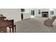 Open living room with neutral carpet, a fireplace, and a kitchen with a breakfast bar at 6103 Pebblebrooke Rd, Whitestown, IN 46075