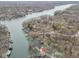 Aerial view of a home nestled among trees with lake access and private boat docks at 6141 Flamingo Dr, Nineveh, IN 46164