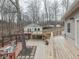 Exterior view of backyard featuring a multi-level deck, outdoor seating, hot tub, and landscaped tree area at 6141 Flamingo Dr, Nineveh, IN 46164