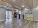 Finished basement features wood ceiling, sliding doors to outside, and small bar area with cabinets and mini fridge at 6141 Flamingo Dr, Nineveh, IN 46164