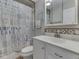 Bathroom featuring a vanity, toilet, shower with decorative shower curtain and tiled walls at 6141 Flamingo Dr, Nineveh, IN 46164
