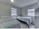 Bedroom featuring two twin beds, a nightstand, and natural light from the two windows at 6141 Flamingo Dr, Nineveh, IN 46164
