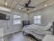 Cozy bedroom with wood-paneled ceiling, ceiling fan, two windows and neutral decor at 6141 Flamingo Dr, Nineveh, IN 46164