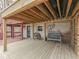 Spacious outdoor living area underneath a deck features seating and exterior access at 6141 Flamingo Dr, Nineveh, IN 46164