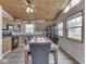 Dining area featuring wooden cabinets, black appliances, wainscoting, a beamed ceiling, and natural light at 6141 Flamingo Dr, Nineveh, IN 46164