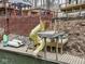 Dock view of a yellow water slide on the water and surrounded by lush greenery at 6141 Flamingo Dr, Nineveh, IN 46164
