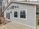 Exterior view shows light gray siding, white trim, and door opening onto a wooden deck at 6141 Flamingo Dr, Nineveh, IN 46164
