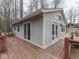 Exterior of a cozy cottage featuring a spacious deck with access from multiple doors and windows at 6141 Flamingo Dr, Nineveh, IN 46164