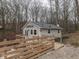View of a gray home with a deck and wooden walkway in a wooded setting at 6141 Flamingo Dr, Nineveh, IN 46164