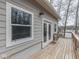 Side exterior view featuring a wooden deck, gray siding, white trim, a window, and a glass door at 6141 Flamingo Dr, Nineveh, IN 46164