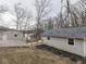 Backyard view featuring the rear of the home, detached garage, wooden deck and distant lake views at 6141 Flamingo Dr, Nineveh, IN 46164