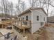 Light gray home features an outdoor deck, stairs and views of the woodsy surround at 6141 Flamingo Dr, Nineveh, IN 46164