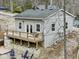 Exterior view of a light gray home with an outdoor deck, seating and a hot tub at 6141 Flamingo Dr, Nineveh, IN 46164