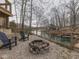 Cozy gravel outdoor area featuring a stone fire pit and two Adirondack chairs near the water at 6141 Flamingo Dr, Nineveh, IN 46164