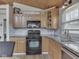Modern kitchen with stainless steel appliances, stone countertops, tile backsplash, and wood cabinets at 6141 Flamingo Dr, Nineveh, IN 46164