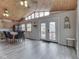 Living room showcasing view of deck and backyard through double doors with transoms and vaulted ceilings at 6141 Flamingo Dr, Nineveh, IN 46164