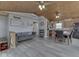 Open floor plan showcasing living room, kitchen with appliances and dining area, all under a vaulted wood ceiling at 6141 Flamingo Dr, Nineveh, IN 46164