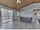 Bright living room featuring a sofa, vaulted ceiling and glass doors that lead to a deck with a private view at 6141 Flamingo Dr, Nineveh, IN 46164