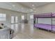 Spacious living room showcases a bunkbed, dining table, and outdoor access to the home's deck at 6141 Flamingo Dr, Nineveh, IN 46164