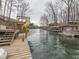 Picturesque waterfront with docks, boat lifts, and a fun slide into the water at 6141 Flamingo Dr, Nineveh, IN 46164