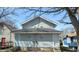 Rear of the house with gray siding and a gabled roof, showing two entry doors and small windows at 621 N Euclid Ave, Indianapolis, IN 46201