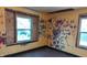 Bedroom needing full renovation with plywood boarded windows and colorful wall designs at 621 N Euclid Ave, Indianapolis, IN 46201
