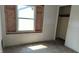 Empty bedroom showing unfinished drywall, hardwood floors, and a closet at 621 N Euclid Ave, Indianapolis, IN 46201
