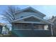 Two-story home featuring gray siding, contrasting trim, and a covered front porch supported by substantial columns at 621 N Euclid Ave, Indianapolis, IN 46201