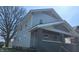 Two story home showing its grey siding and black trim, with unfinished landscaping at 621 N Euclid Ave, Indianapolis, IN 46201