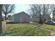 Detached garage with a side entry door and a paved path leading to it, in a grassy backyard at 621 N Euclid Ave, Indianapolis, IN 46201