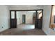 Spacious room featuring hardwood floors, decorative columns, and large windows, under renovation at 621 N Euclid Ave, Indianapolis, IN 46201