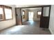 Open-concept room featuring hardwood floors, decorative columns, and exposed framework, ready for renovation at 621 N Euclid Ave, Indianapolis, IN 46201