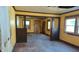 Spacious living room needing a remodel, featuring original wood floors and windows for natural light at 621 N Euclid Ave, Indianapolis, IN 46201