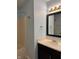 Bathroom with black framed mirror and vanity with modern light fixture and accessories at 6318 Amarillo Way, Indianapolis, IN 46237