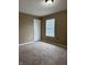 This cozy carpeted bedroom has a double door closet and a window for natural lighting at 6318 Amarillo Way, Indianapolis, IN 46237