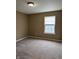 Cozy carpeted bedroom features a window for plenty of natural light at 6318 Amarillo Way, Indianapolis, IN 46237