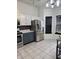 Bright kitchen area with stainless steel refrigerator and tile flooring at 6318 Amarillo Way, Indianapolis, IN 46237