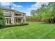 Well-manicured backyard with a large grassy area and view of the home's rear exterior at 6430 Meridian Pkwy # Apt A, Indianapolis, IN 46220