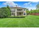 Spacious backyard features an expansive lawn and a two-story home with a balcony at 6430 Meridian Pkwy # Apt A, Indianapolis, IN 46220